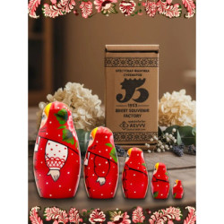 Wooden matryoshka doll in a red scarf and sarafan with an ornament